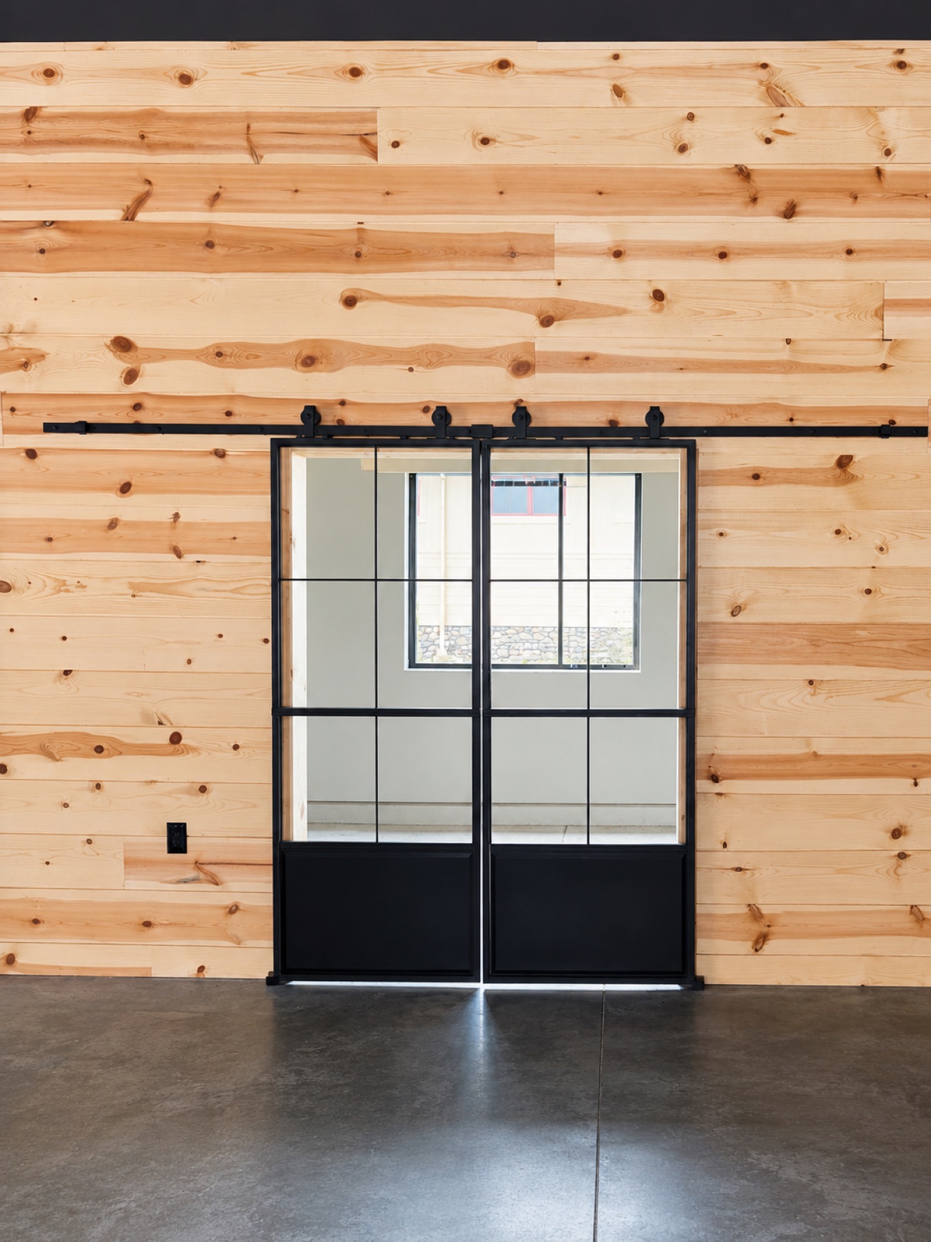 Wood-clad interior with steel sliding doors